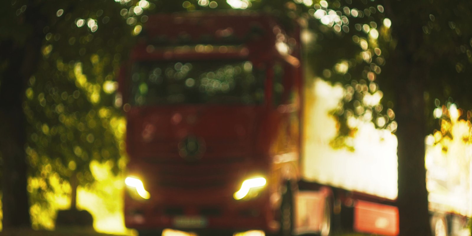 Red vehicle and cinematic bokeh in a film still from La Vialette by Feel Inc.