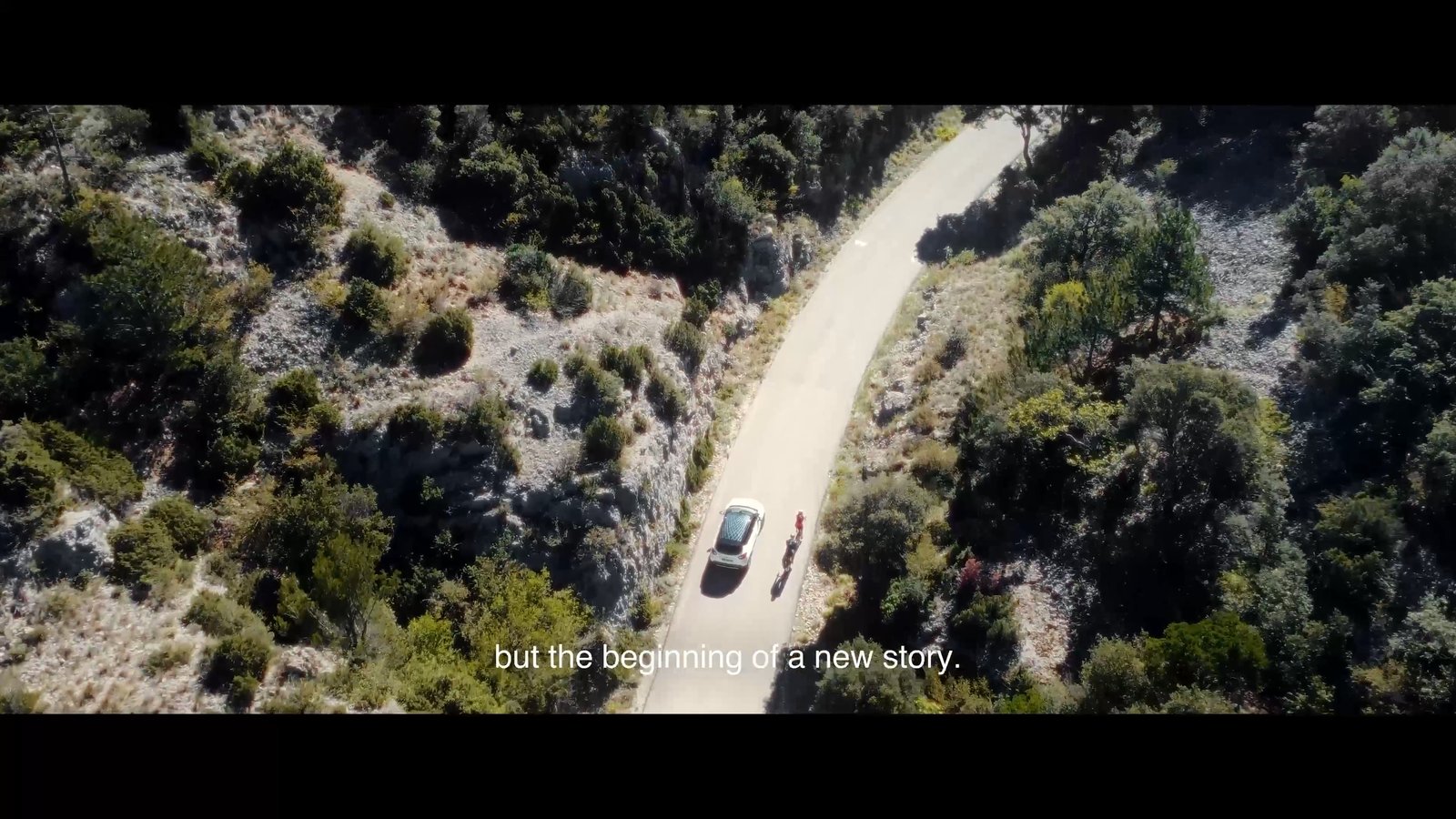 Aerial view of a car crossing a mountain road in The Dr Pure film by Feel Inc.