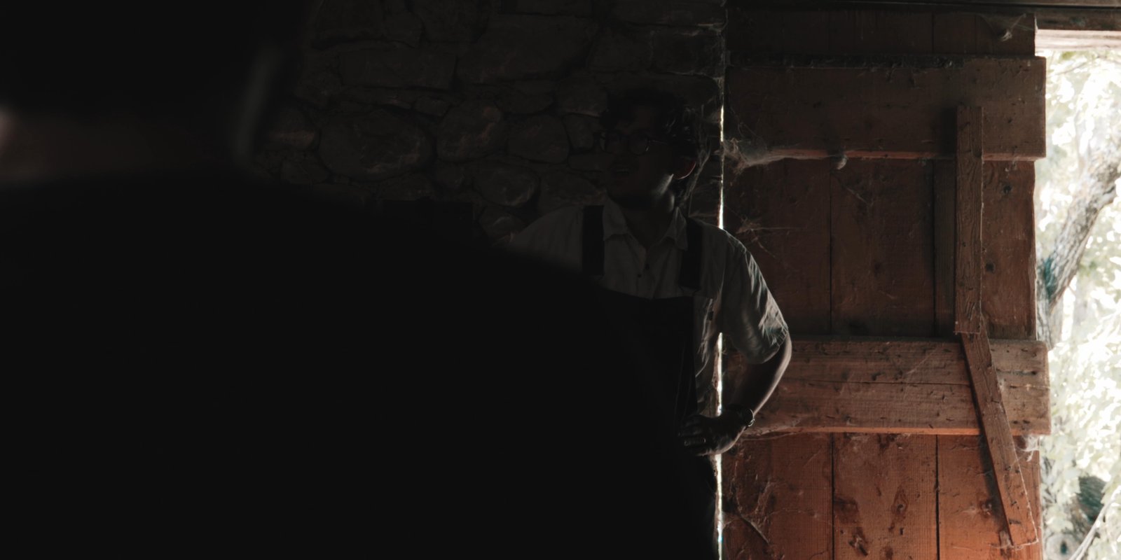 A figure framed by a dark doorway in the Feel Inc. short film Why Not Before